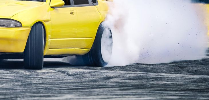 Race drift car burning tires on speed track