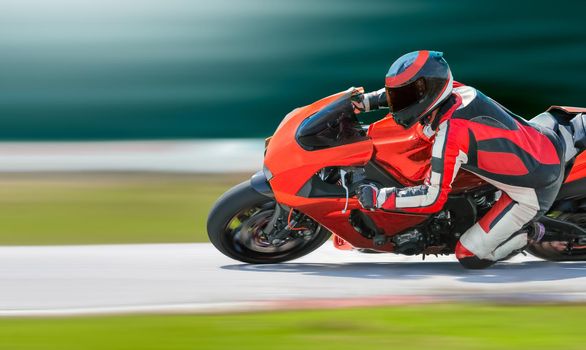 Motorcycle leaning into a fast corner on race track