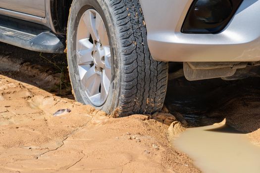 car stuck in muddy road
