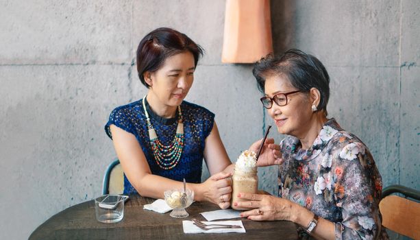 Daughter take care mother in restaurant