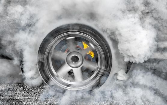 Drag racing car burns rubber off its tires in preparation for the race