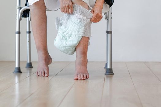 elderly woman changing diaper