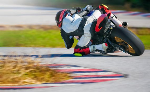 Motorcycle leaning into a fast corner on race track