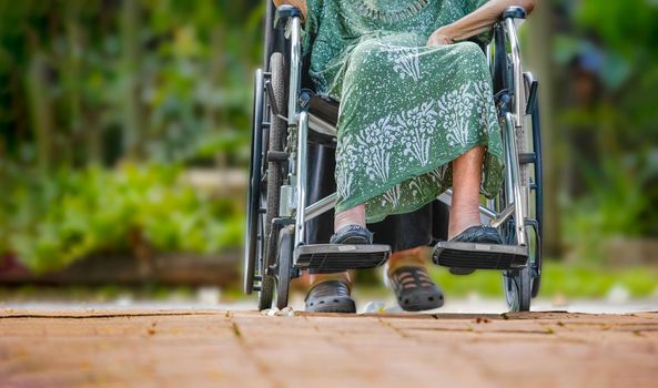 Elderly woman on wheelchair at home with daughter take care