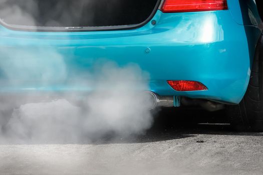 air pollution crisis from car exhaust pipe on road