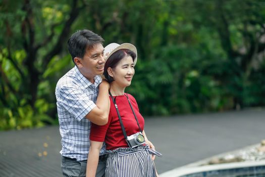 Asian middle aged man relaxing with his wife in anniversary wedding day