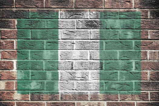 A Nigeria flag on old brick wall background