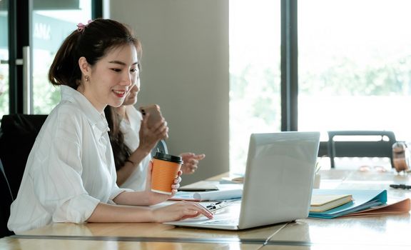 Portrait Of Attractive Asian Businesswoman Working On Laptop for business strategy planning