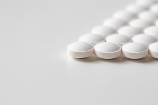 Rows of pills on a white background. Health care, medicine, pharmacy and disease concept