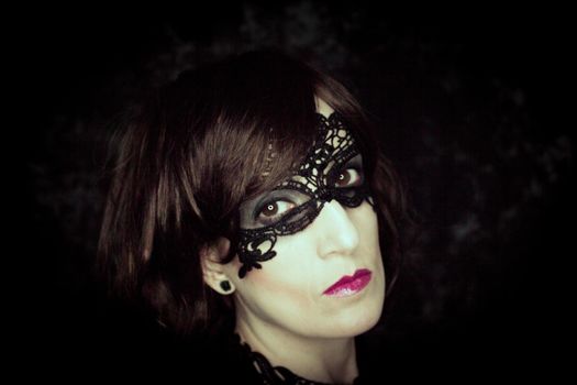 Woman disguised in gothic style for halloween party with mask