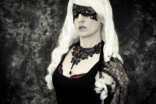 Woman disguised in gothic style for halloween party with mask