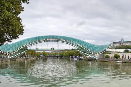 View of Kura river with bridge of Peace in Tbilisi, Georgia