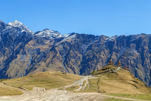 Landscape with Gergeti Trinity Church and mountains, Georgia