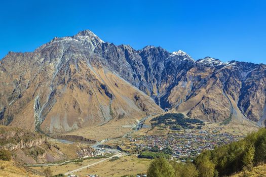 View of Stepantsminda on a background of mountains, Georgia