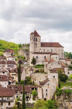 View of Saint-Cirq-Lapopie village with catholic church, France