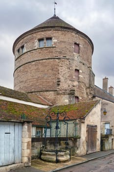 Street with tower in Semur en Auxois, France