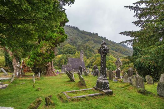 Celtic cross in a graveyard in Glendalough, Ireland