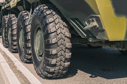 Large wheels of an armored infantry vehicle close-up while parked at the Museum of Military Equipment