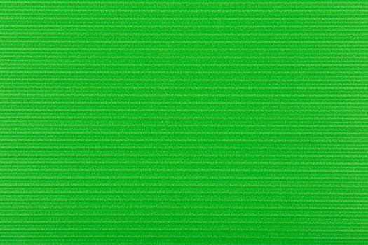 Green wall texture with horizontal stripes. Green paper background. Flay, copy space. 