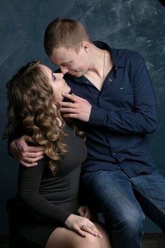 Portrait of a beautiful couple in love on a dark background.