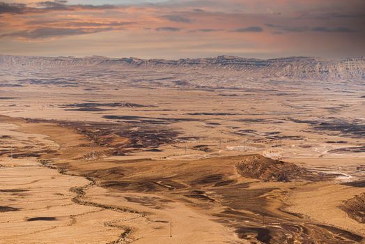 Ramon Crater Makhtesh Ramon, the largest in the world, as seen from the high rocky cliff edge surrounding it from the north, Ramon Nature reserve, Mitzpe Ramon, Negev desert, Israel. High quality photo