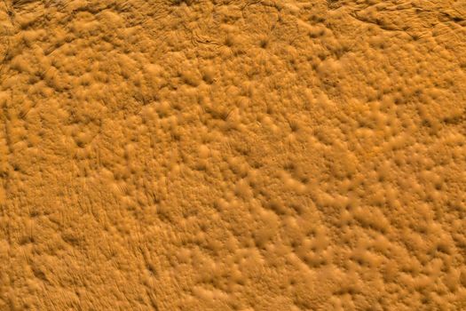 orange sculpturesque plaster with decorative indentation finish wall texture and background