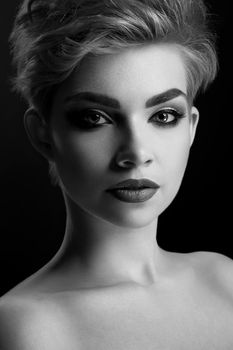 Silent beauty. Vertical monochrome close up of a gorgeous young woman wearing professional makeup shadow mystery elegance femininity sensuality sexy seductive black and white beauty face makeup