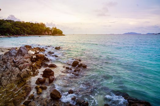 Beautiful tropical nature landscape colorful the sky at sunset over the sea rocks and resort on the beach in summer at the Sunset Beach on Koh Lipe island, Tarutao National Park, Satun, Thailand