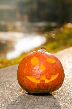 Jack. Shot of a carved pumpkin with a smiling face in the park