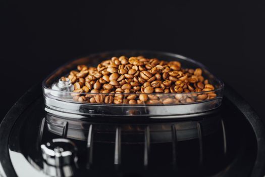coffee beans in coffeemaker bean container, close-up view