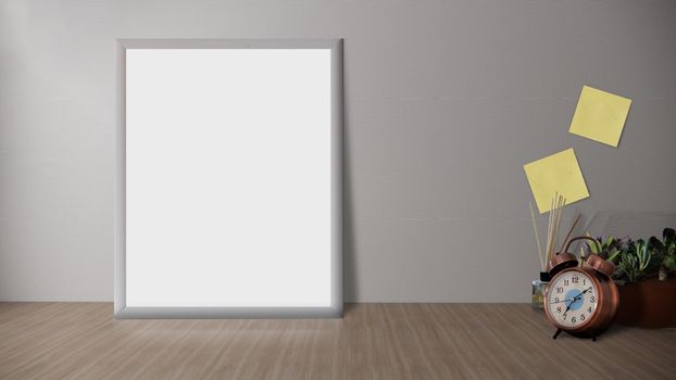 Wooden desk with photo frame and minimal round vase with a decorative twig against white wall.