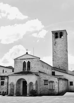 Medieval church of Santa Maria Infraportas in Foligno ,entrance with porch with arches ,beautiful bell tower, black and white photography