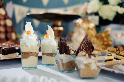 chocolate desserts in parfait cups on a white table, decor with chocolate desserts, festive table with desserts.