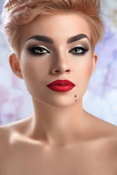 Extremely gorgeous. Vertical close up of a gorgeous young woman with perfect skin wearing dark smoky eyes makeup and red lipstick sensual feminine seductive sexy beauty cosmetics salon fresh concept