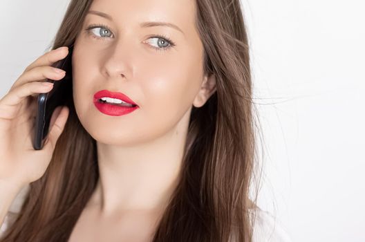 Happy smiling woman calling on smartphone, portrait on white background. People, technology and communication concept.