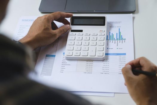 American african with a savings account calculates the amount of money he can save this year. account or saving money or insurance concept