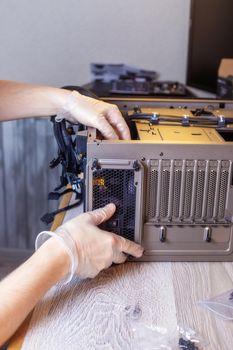 Technician is installing a new power supply into a computer.