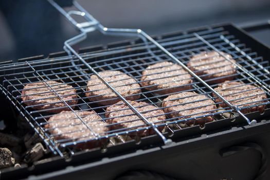 Fried meat patties for a hamburger.Grilled meat. A piece of meat in the smoke.