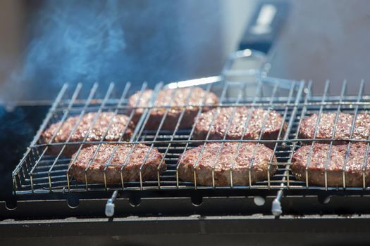 Fried meat patties for a hamburger.Grilled meat. A piece of meat in the smoke.
