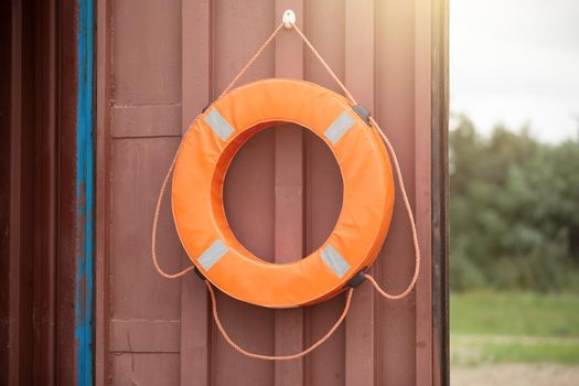 A life buoy is hanging on the door.
