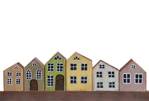 Wooden toy houses on a white background. Miniature town made of wood.