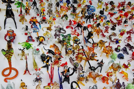 A large number of various toys made of glass.