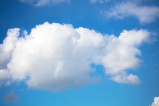 Blue sky with a fluffy white cloud.