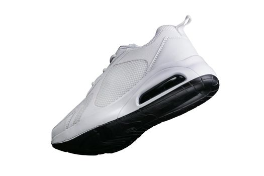 White sneaker with black accents isolated. Sports shoes on a white background.