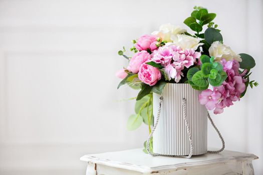 Beautiful peonies in a paper box on a white background.