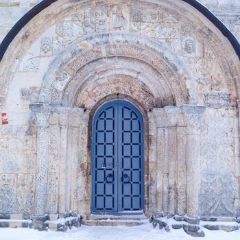 Old gate of monastery in winter. Lots of snow, Russia.