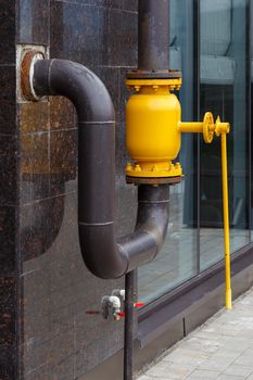 large opened yellow natural gas ball valve with long straight lever