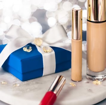 Cosmetic branding, Christmas glitter and girly blog concept - Holiday make-up foundation base, concealer and blue gift box, luxury cosmetics present and blank label products for beauty brand design