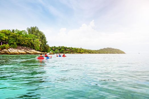 Tourist group are kayaking on the sea, travel by boat to see the beautiful nature landscape in the morning of summer at front the resort around Ko Lipe island, Tarutao National Park, Satun, Thailand