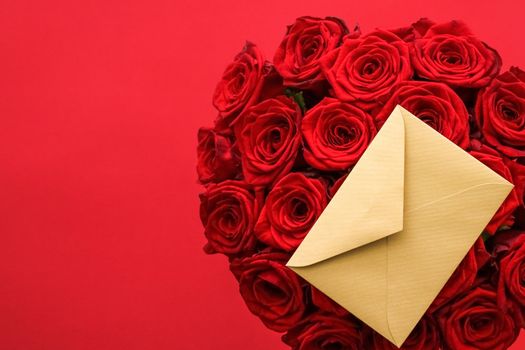 Holiday gift, flowers flatlay and happy relationship concept - Love letter and flower delivery service on Valentines Day, luxury bouquet of red roses and card envelopes on red background